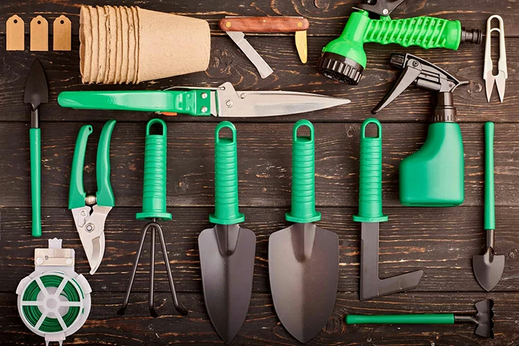 Gardening tools on wooden background flat lay