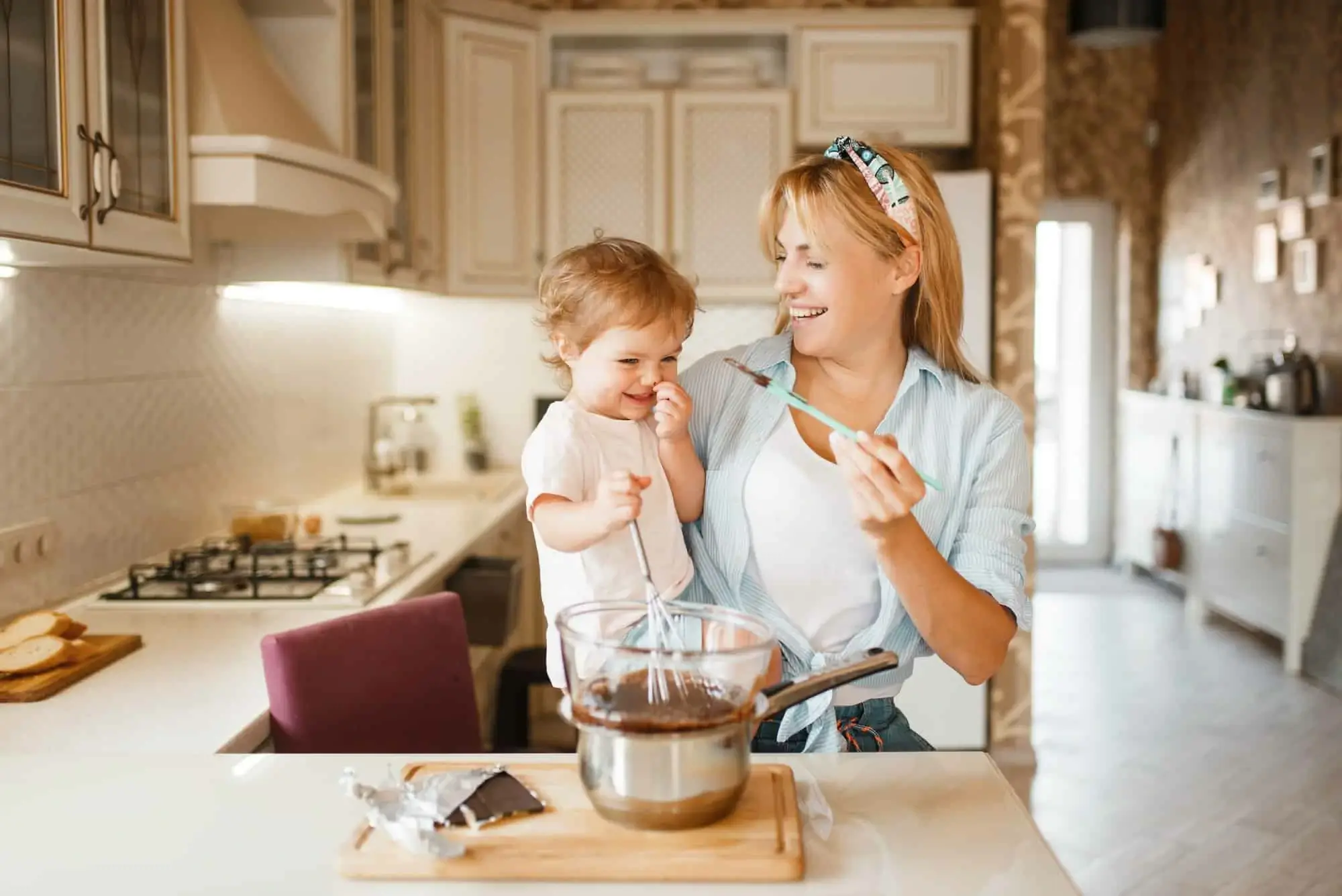 Mother with her daughter mixing melted chocolate