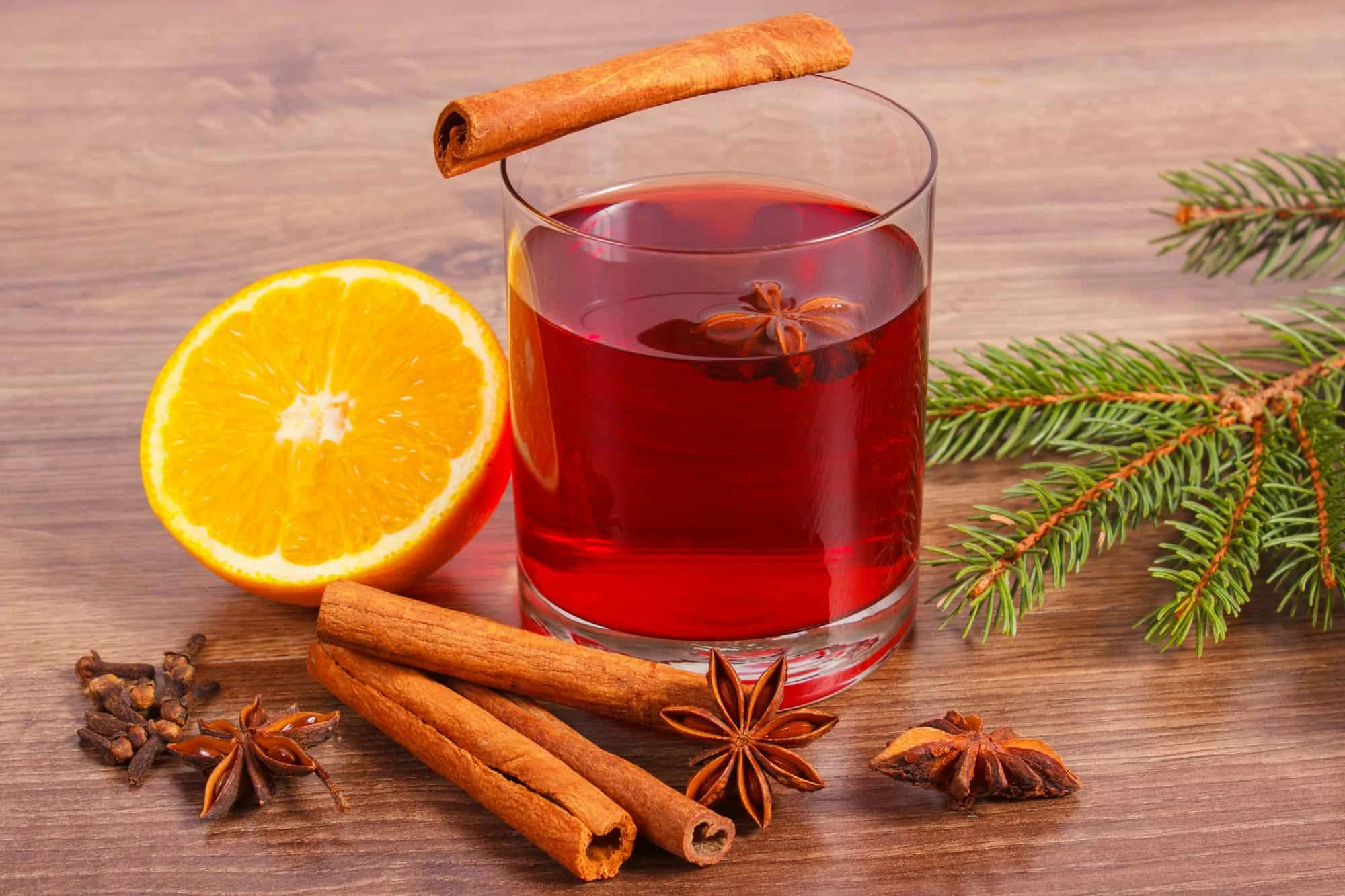 Mulled wine for christmas or winter evening with spices and spruce branches
