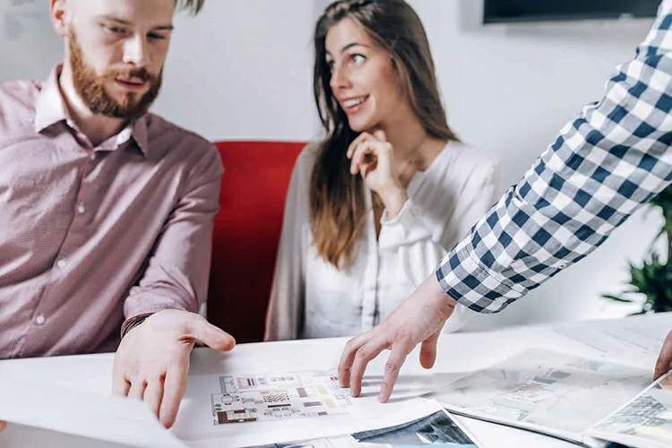 Real Estate Agency. Couple Looking at a Model of Their New Home